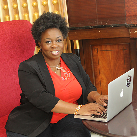 Michele Heyward, Founder PositiveHire sitting in front of a laptop